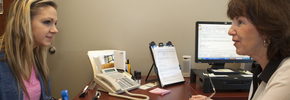 A student meeting with a member of enrollment services