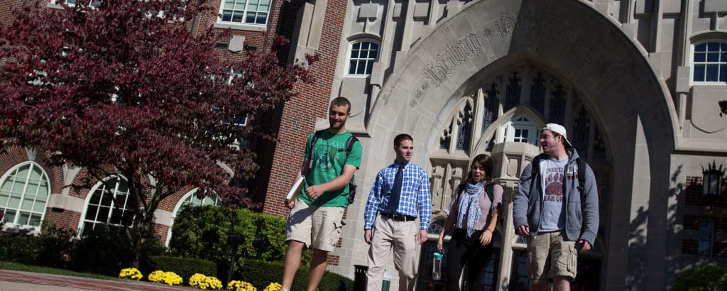 Providence College Students Walking in the Spring Outside of Harkins Hall
