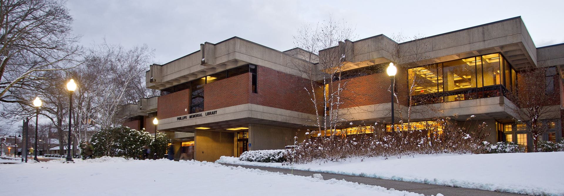 Library, a Brick Building, with Snow on the Ground and a Cleared Sidewalk.
