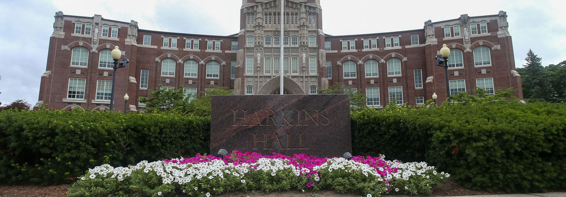 Harkins Hall with Flowers in Bloom and American Flag