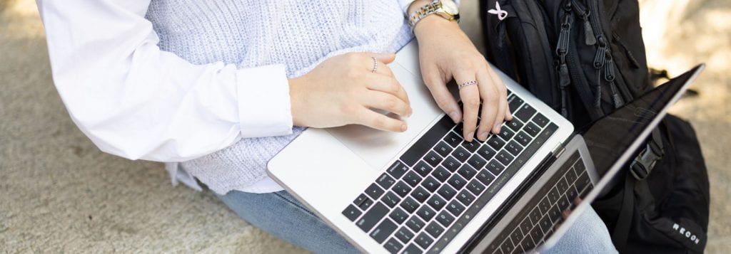 A Student Holding a Laptop